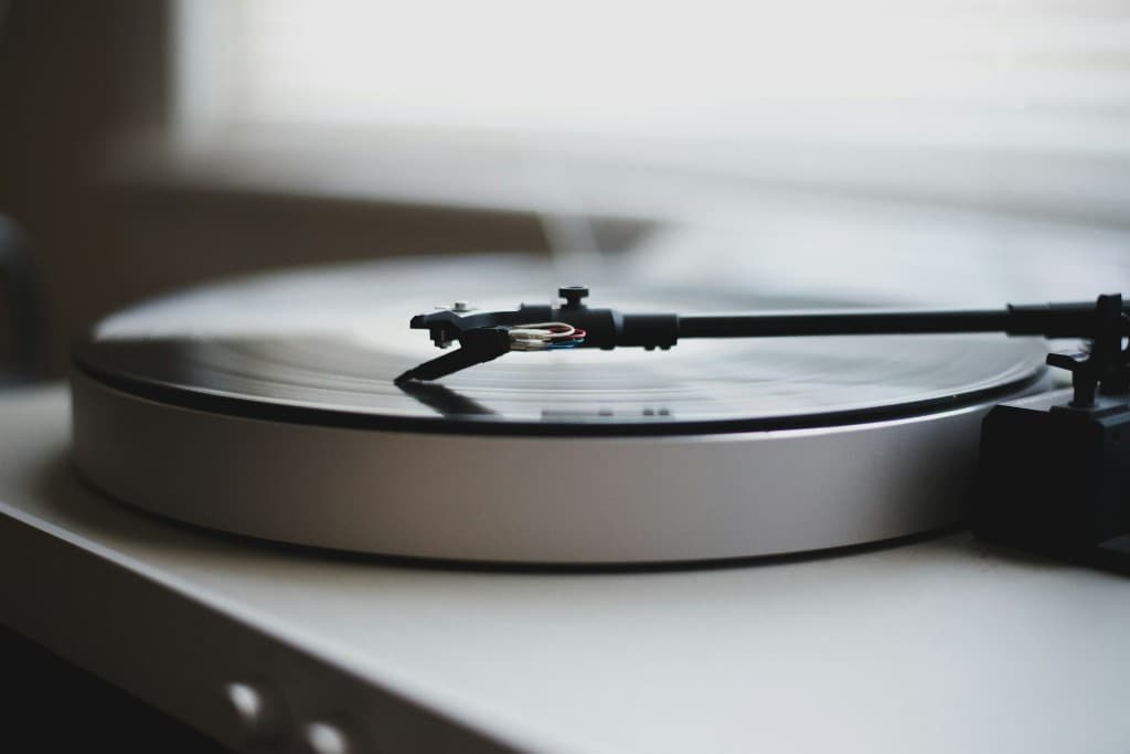Record player with needle on a spinning vinyl record.