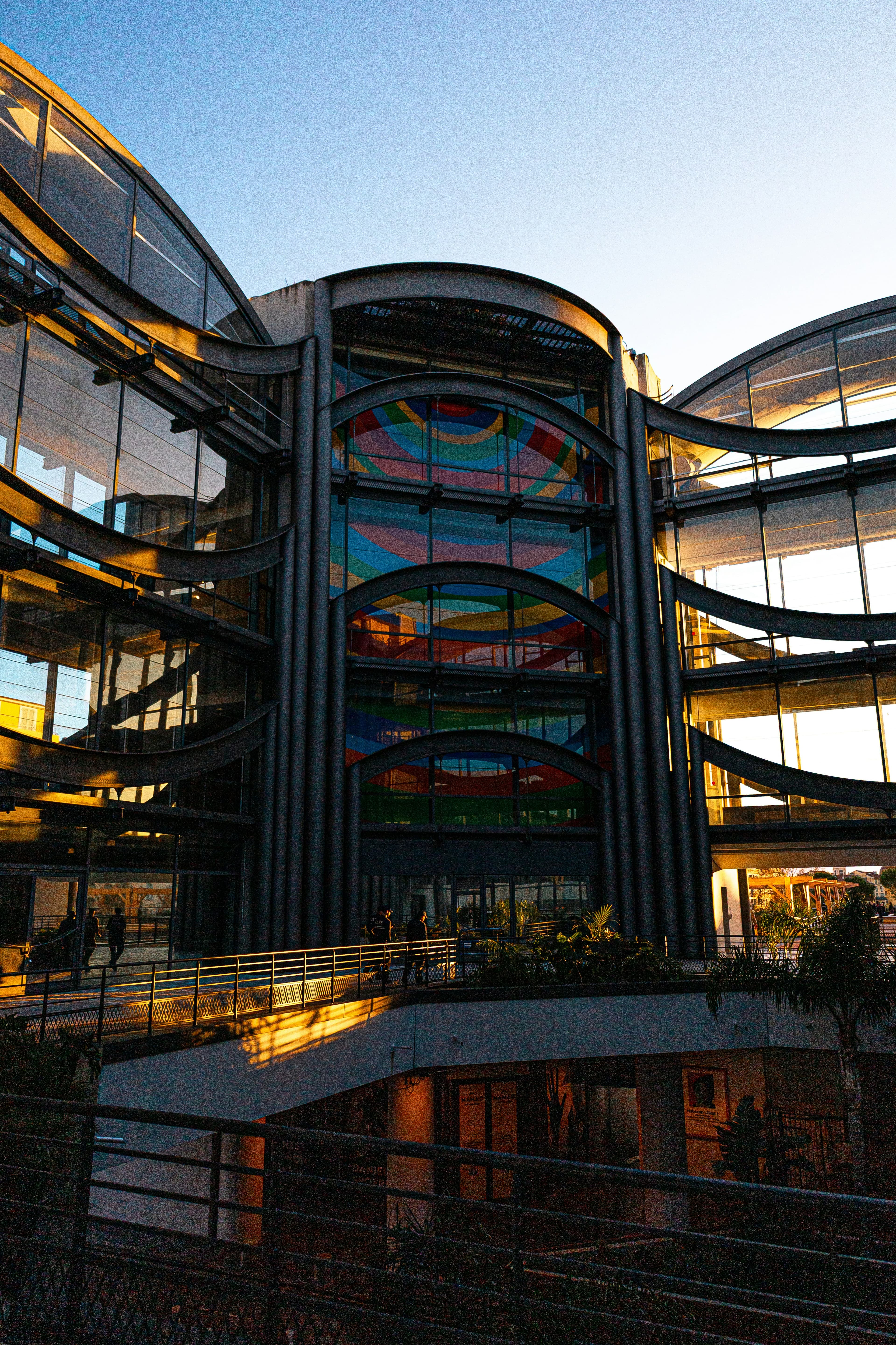 Colorful stained-glass facade of a modern building, shot from below.